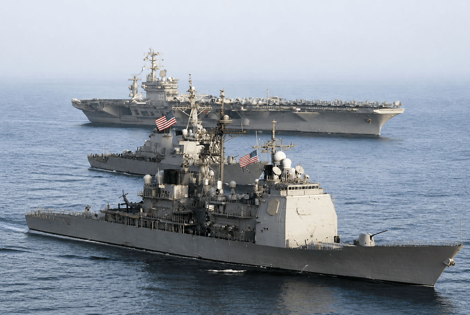 A guided-missile cruiser and aircraft carrier underway at sea